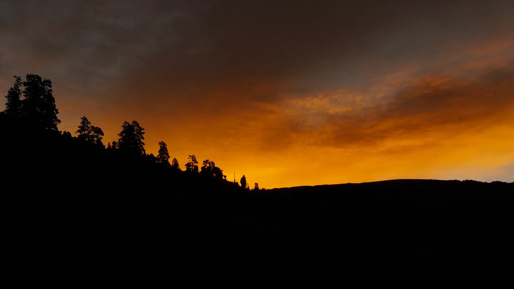 Orange sunset sky above the silhouette of the Ali Bugyal ridge