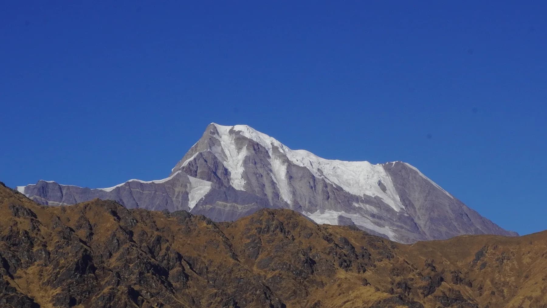 Snow-covered Nanda Ghunti peak under a clear blue sky