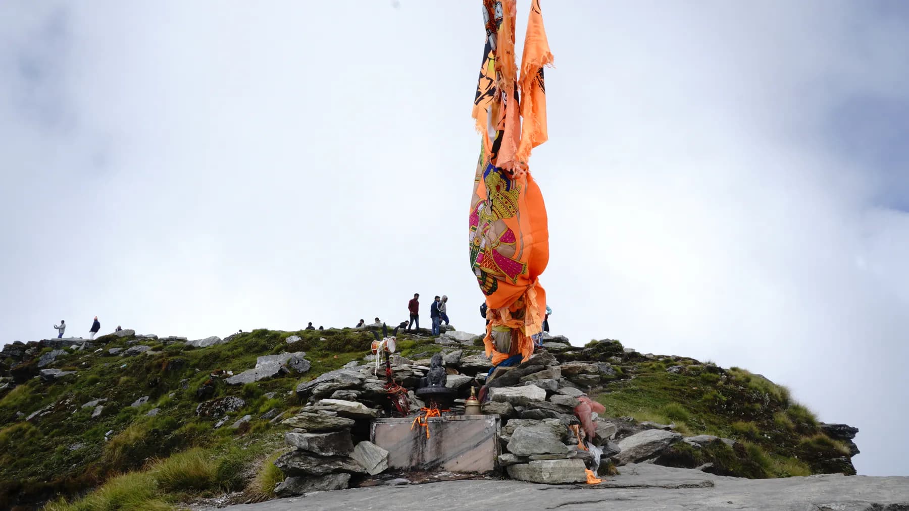 Prayer flags and stone shrine at the Chandrashila summit