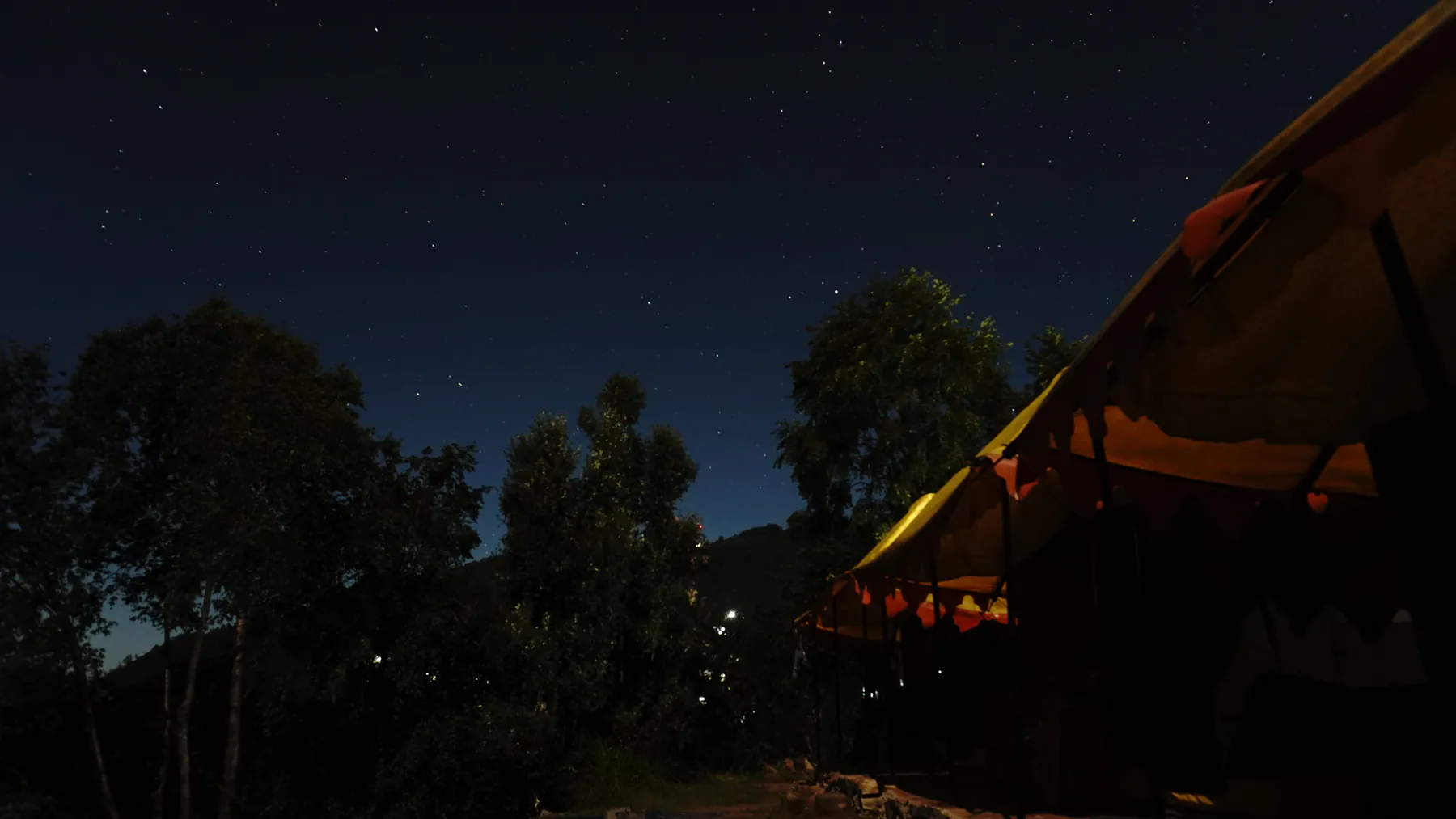 Star-filled night sky above the alpine base camp at Sari Village