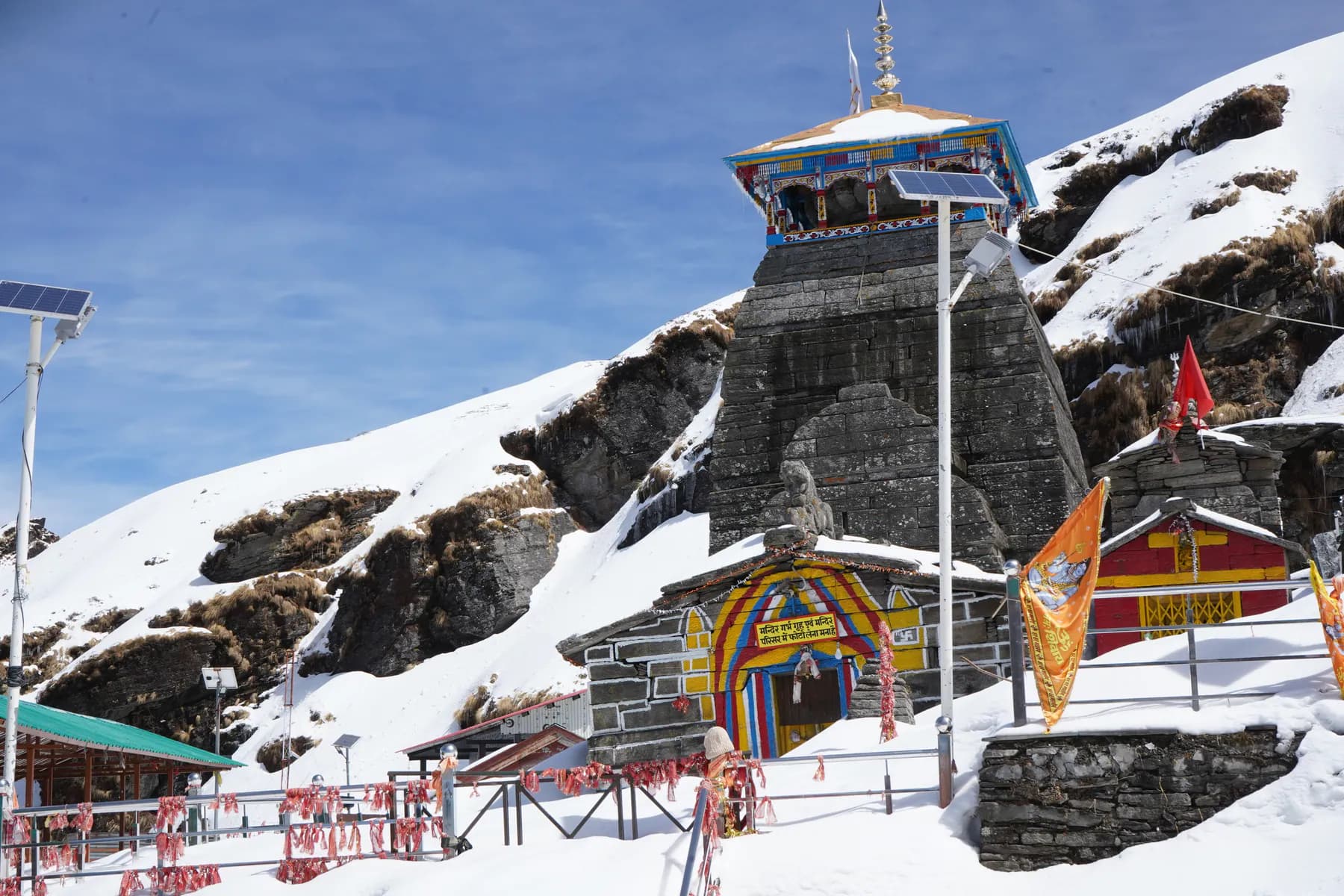 Tungnath Temple surrounded by deep snow under a blue sky