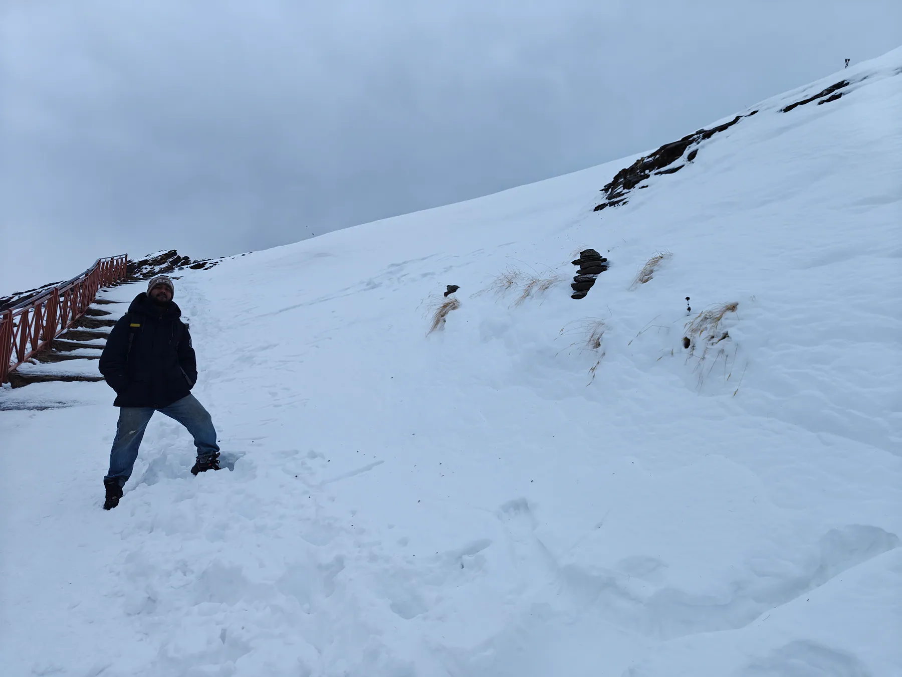 Trekker standing in deep winter snow on the upper Tungnath trail