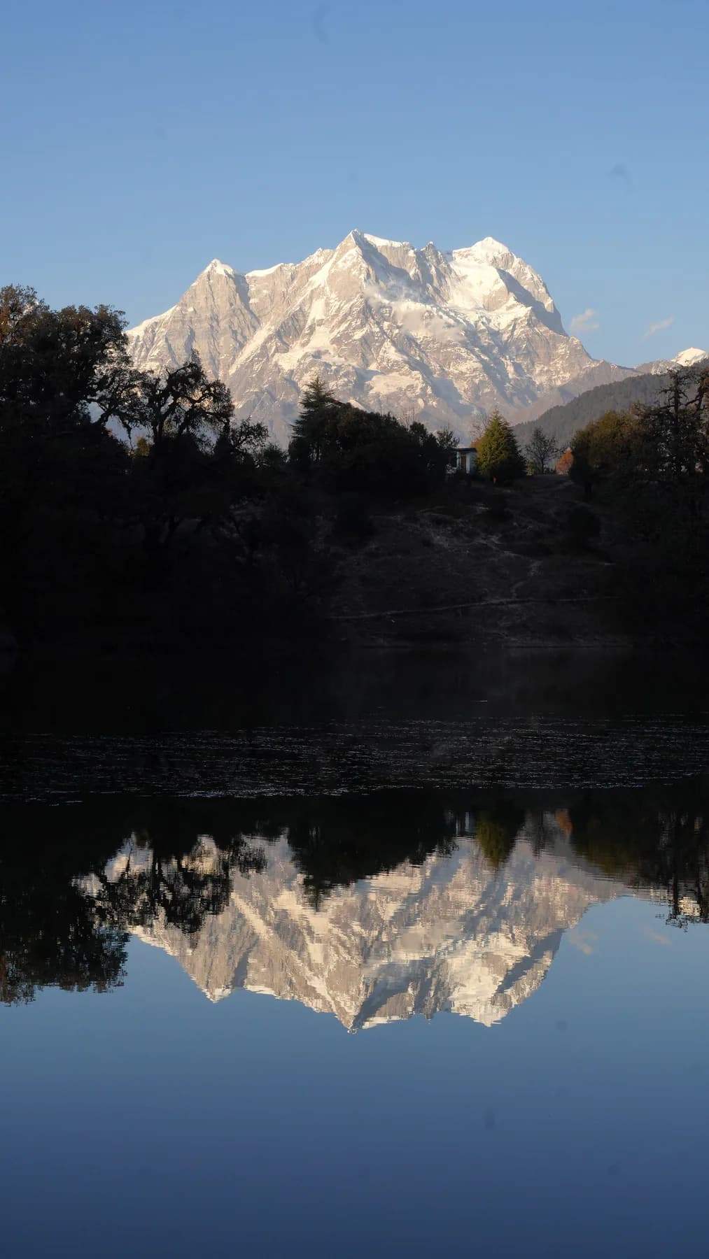 Vertical view of Chaukhamba reflected in the still water of Deoriatal