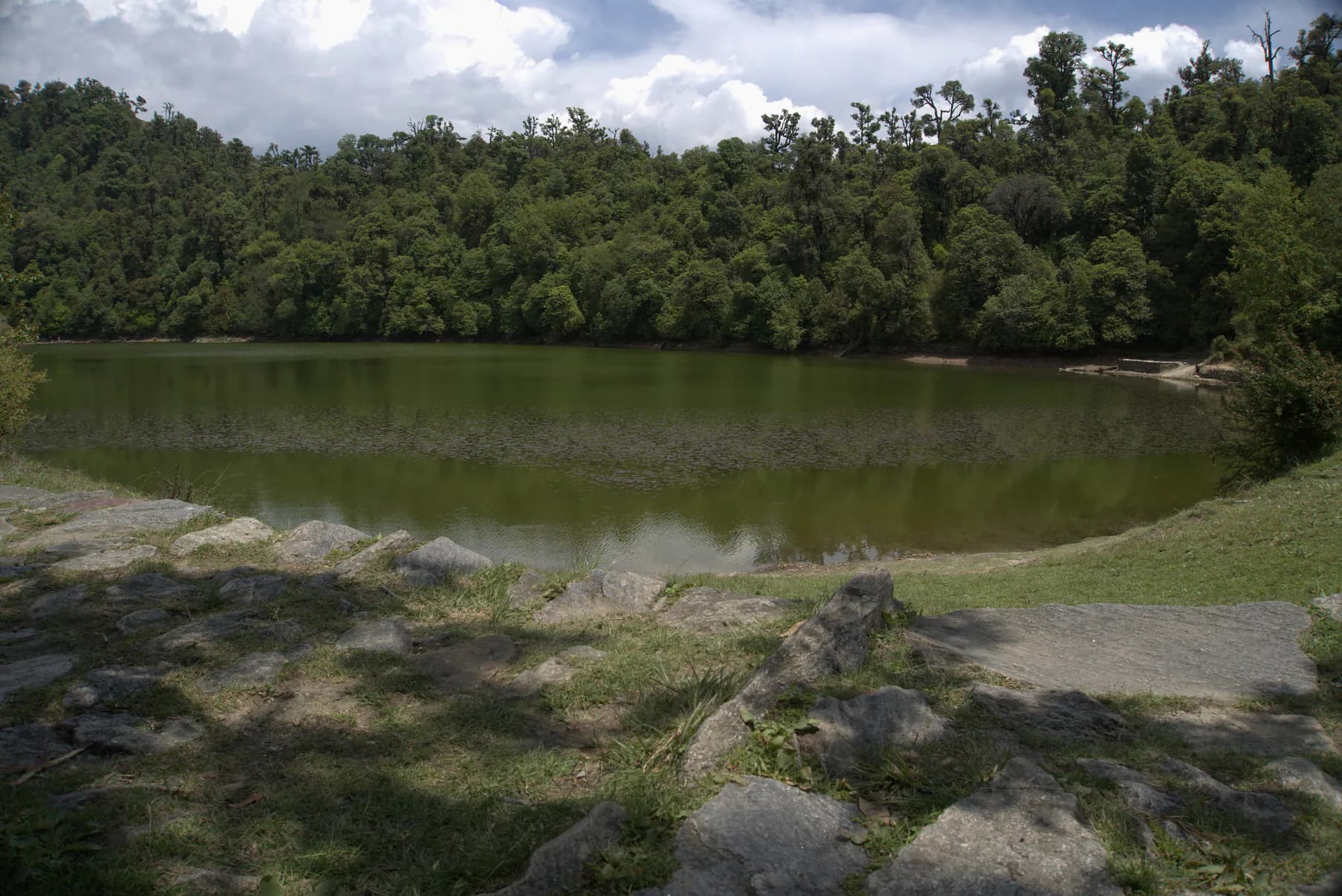 Deoriatal lake surrounded by dense green Himalayan forest