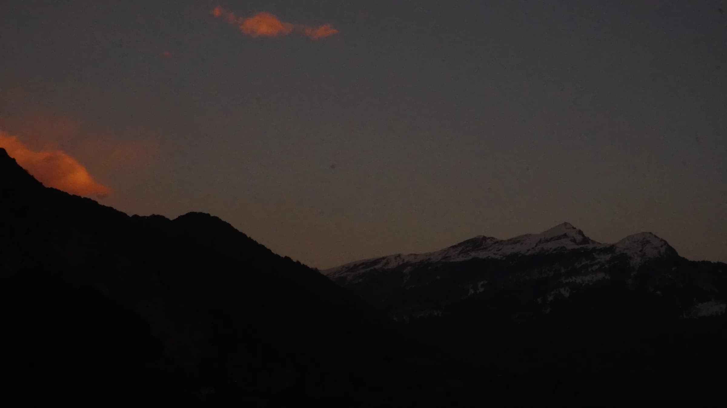 A snowy Himalayan ridge beneath a warm twilight sky