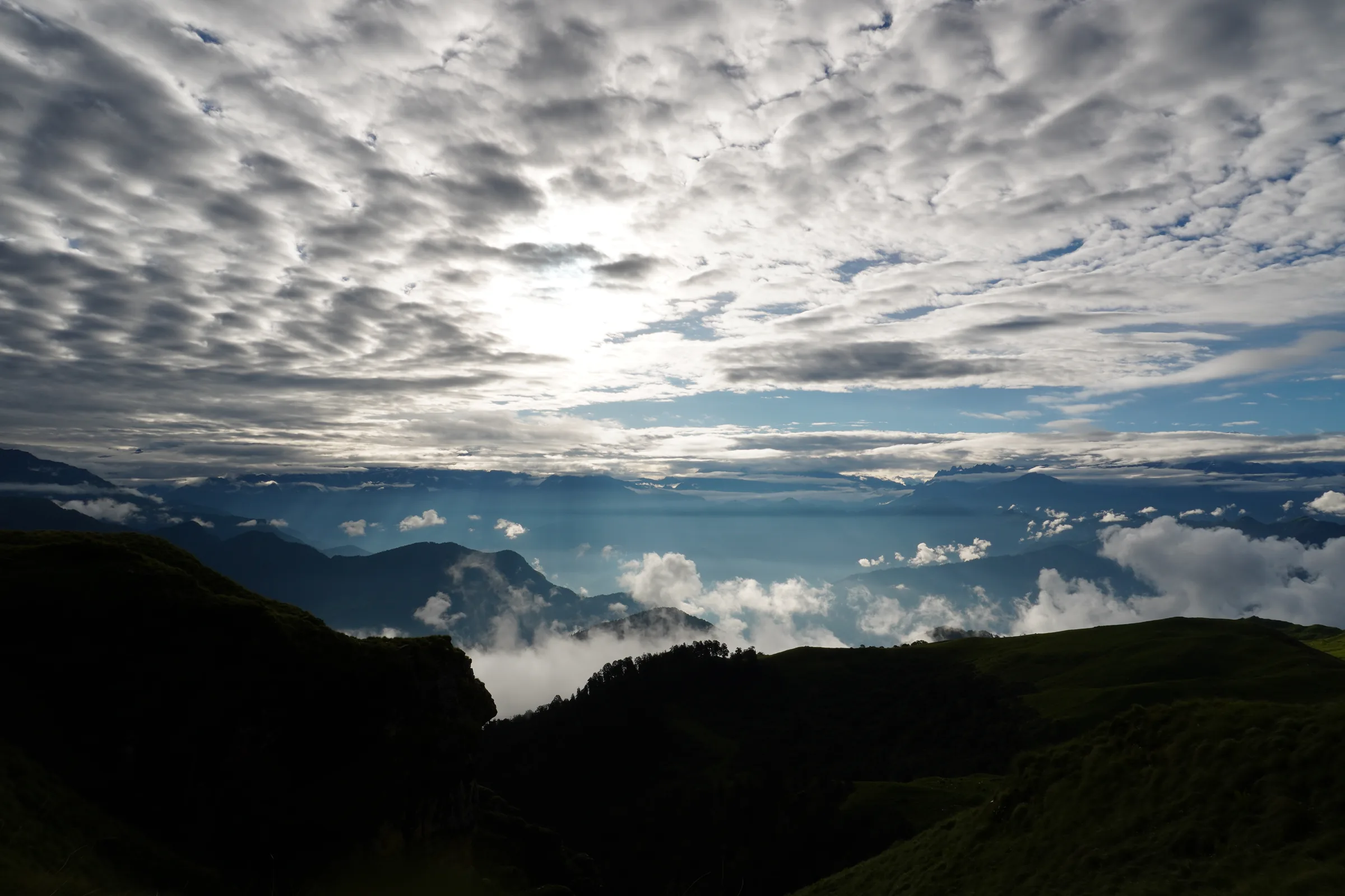 Dramatic clouds and layered mountain valleys seen from the Rudranath trail