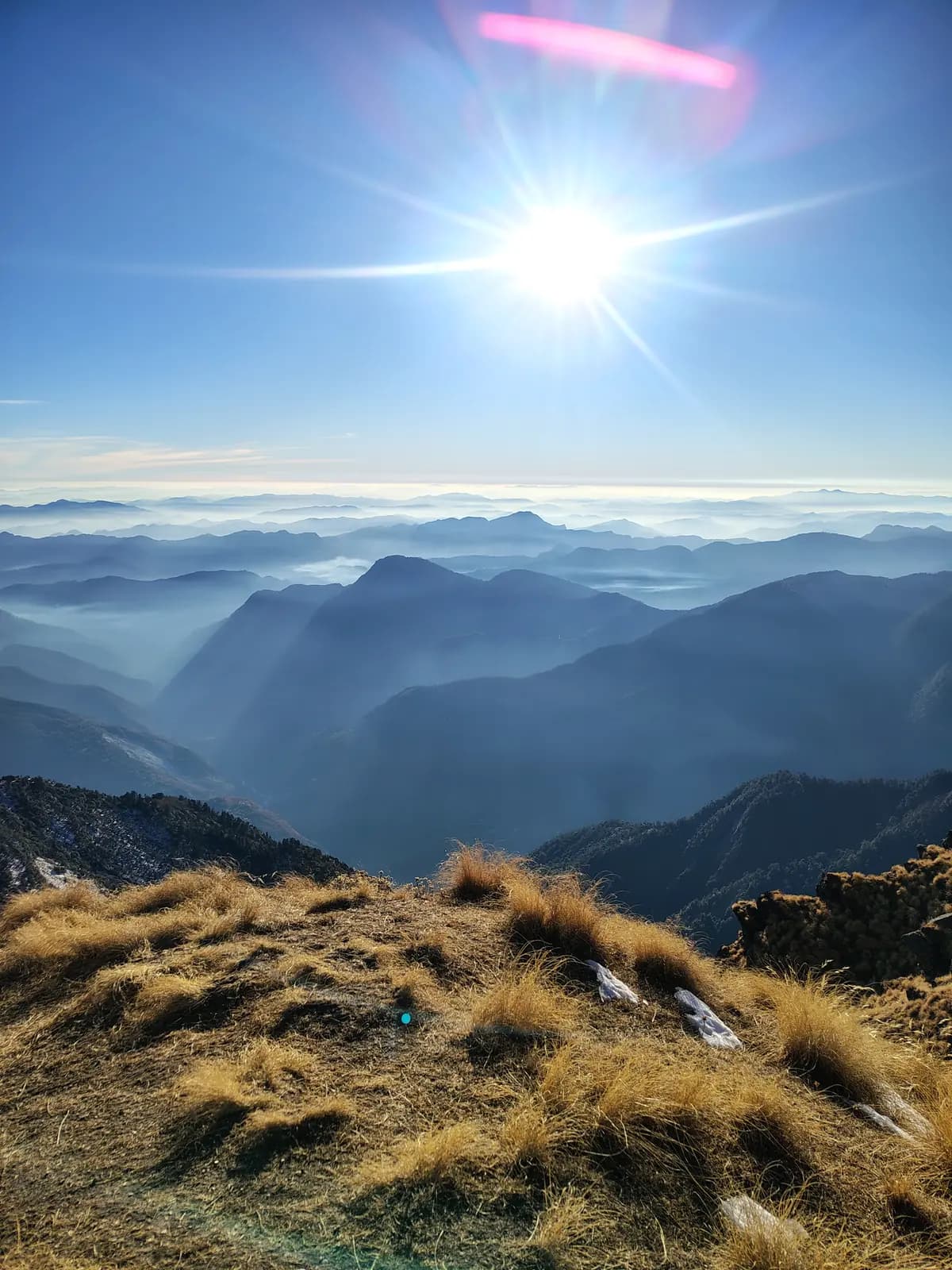 Sunlit layered valleys and golden grass from Khaliya Top